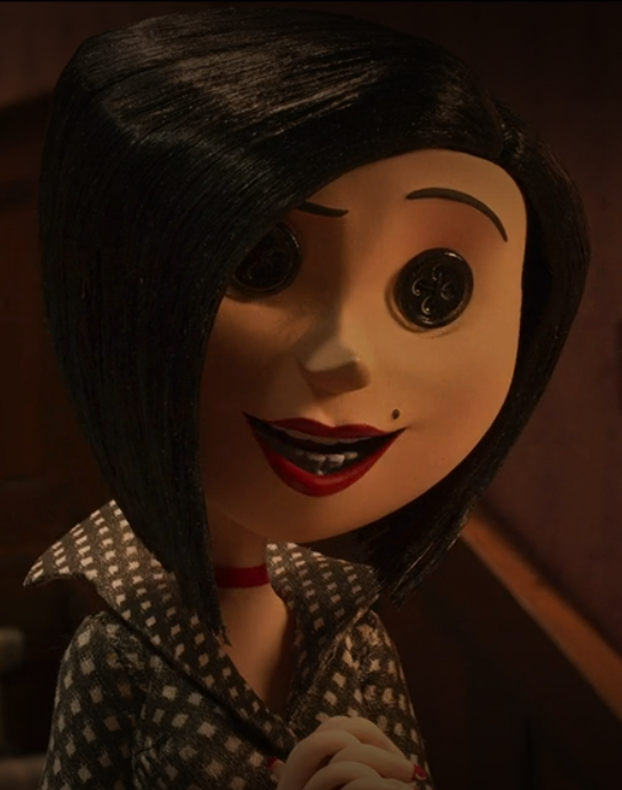 The Other Mother from Coraline, in her "normal" form with a sharp, slightly upturned nose, red lipstick, a dark bob, and a black and white polka dotted blouse with a stiff collar.